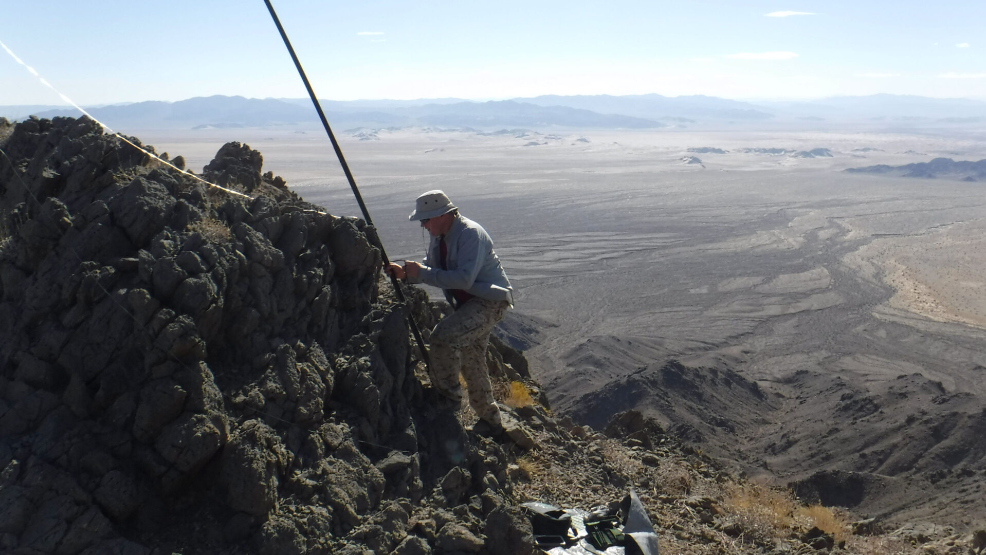 Amateur radio operator securing an antenna mast for Summits on the Air